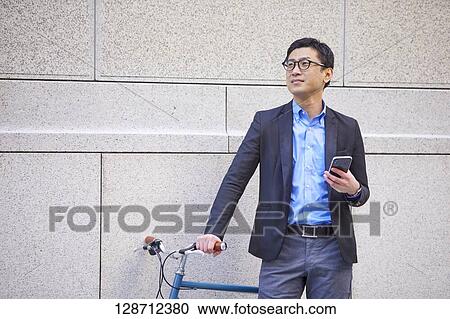 Middle Aged Japanese Businessman Riding A Bicycle View Large Photo Image Stock Image - Middle Aged Japanese Businessman Riding A Bicycle. Fotosearch