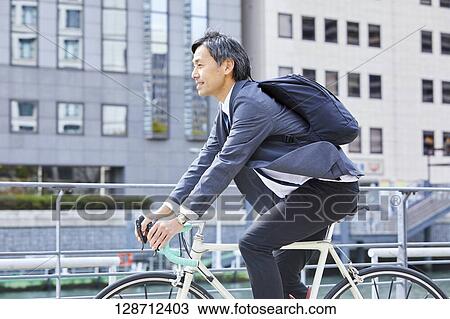 Middle Aged Japanese Businessman Riding A Bicycle View Large Photo Image Stock Image - Middle Aged Japanese Businessman Riding A Bicycle. Fotosearch
