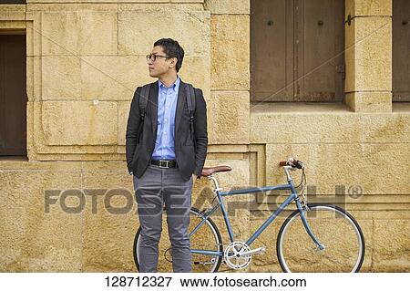Stock Photo - Middle Aged Japanese Businessman Riding A Bicycle. Fotosearch