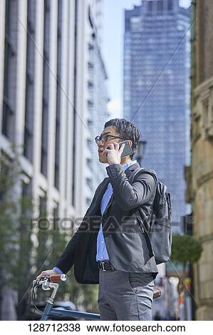 Middle Aged Japanese Businessman Riding A Bicycle View Large Photo Image Stock Photo - Middle Aged Japanese Businessman Riding A Bicycle. Fotosearch