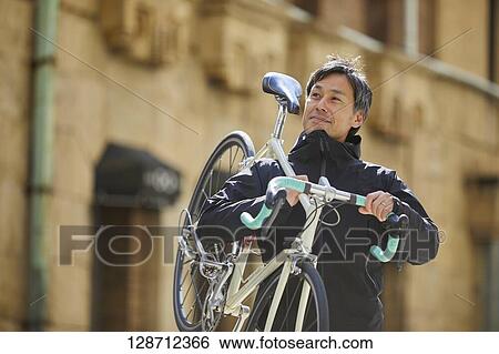 Middle Aged Japanese Businessman Riding A Bicycle View Large Photo Image Stock Photograph - Middle Aged Japanese Businessman Riding A Bicycle. Fotosearch