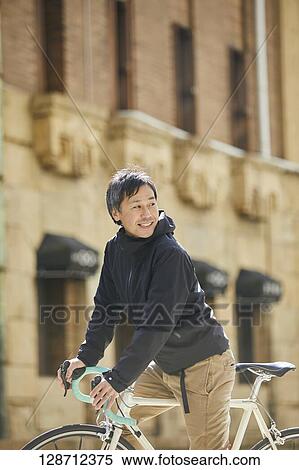Middle Aged Japanese Businessman Riding A Bicycle View Large Photo Image Stock Photography - Middle Aged Japanese Businessman Riding A Bicycle. Fotosearch