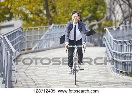 Middle Aged Japanese Businessman Riding A Bicycle View Large Photo Image Stock Photography - Middle Aged Japanese Businessman Riding A Bicycle. Fotosearch