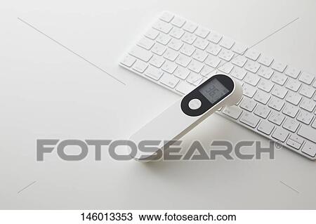 Stock Image - Non-contact thermometer. Fotosearch