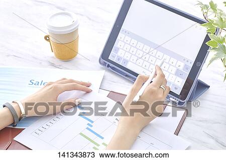 Stock Image - Paper Work With A Tablet PC. Fotosearch