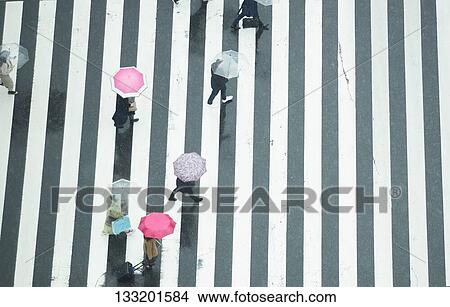 Picture - People Crossing A Crossroad On A Rainy Day In Tokyo, Japan. Fotosearch