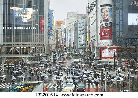 Picture - People Crossing A Crossroad On A Rainy Day In Tokyo, Japan. Fotosearch