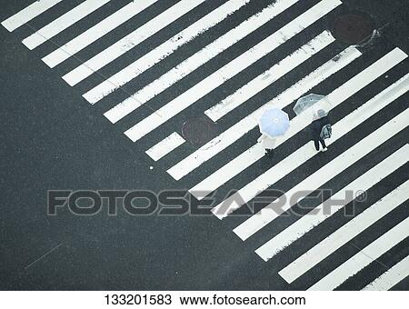 People Crossing A Crossroad On A Rainy Day In Tokyo, Japan View Large Photo Image Stock Image - People Crossing A Crossroad On A Rainy Day In Tokyo, Japan. Fotosearch