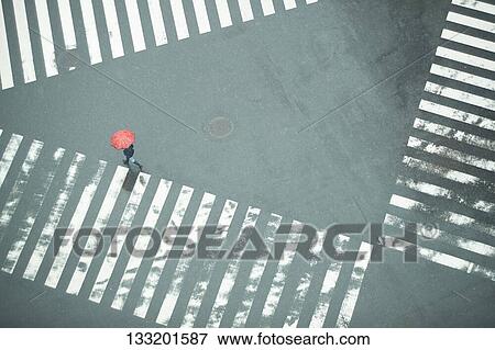 Stock Photo - People Crossing A Crossroad On A Rainy Day In Tokyo, Japan. Fotosearch