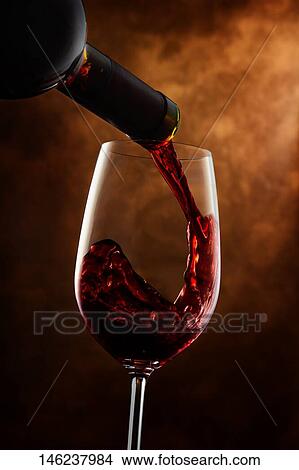 Pouring wine in a glass View Large Photo Image Picture - Pouring wine in a glass. Fotosearch