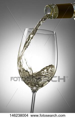 Pouring wine in a glass View Large Photo Image Picture - Pouring wine in a glass. Fotosearch