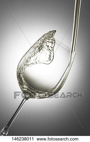 Stock Image - Pouring wine in a glass. Fotosearch