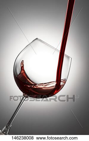 Stock Photo - Pouring wine in a glass. Fotosearch