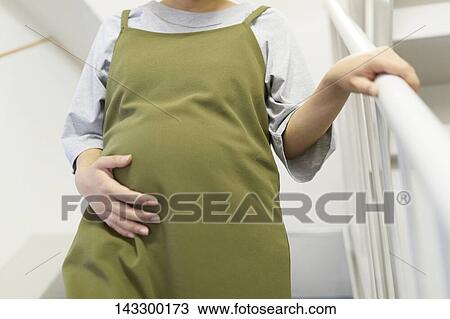 Pregnant Japanese woman on staircase View Large Photo Image Stock Image - Pregnant Japanese woman on staircase. Fotosearch