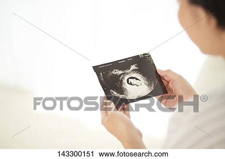 Stock Image - Pregnant Japanese woman. Fotosearch