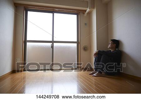 Sad Japanese man in empty apartment View Large Photo Image Stock Photo - Sad Japanese man in empty apartment. Fotosearch