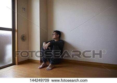 Sad Japanese man in empty apartment View Large Photo Image Stock Photo - Sad Japanese man in empty apartment. Fotosearch