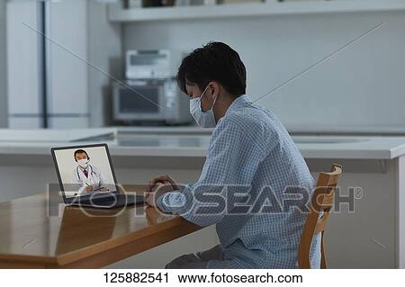 Sick Japanese man working from home View Large Photo Image Stock Image - Sick Japanese man working from home. Fotosearch