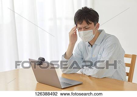 Sick Japanese man working from home View Large Photo Image Stock Image - Sick Japanese man working from home. Fotosearch