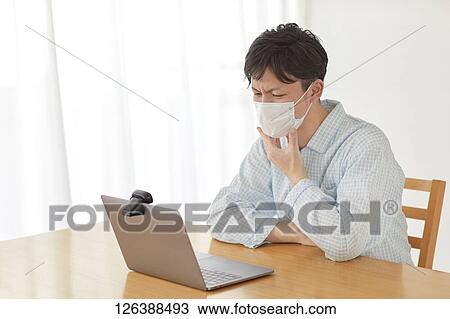 Sick Japanese man working from home View Large Photo Image Stock Image - Sick Japanese man working from home. Fotosearch