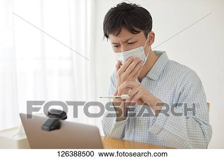 Sick Japanese man working from home View Large Photo Image Stock Image - Sick Japanese man working from home. Fotosearch