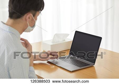 Sick Japanese man working from home View Large Photo Image Stock Image - Sick Japanese man working from home. Fotosearch