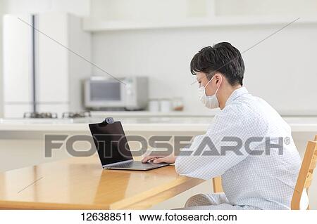 Sick Japanese man working from home View Large Photo Image Stock Image - Sick Japanese man working from home. Fotosearch