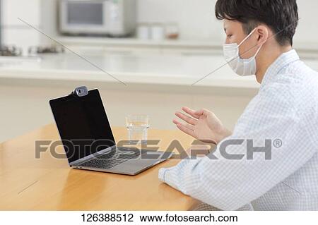 Sick Japanese man working from home View Large Photo Image Stock Image - Sick Japanese man working from home. Fotosearch
