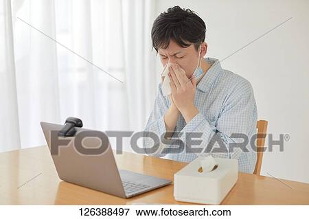 Sick Japanese man working from home View Large Photo Image Stock Photo - Sick Japanese man working from home. Fotosearch
