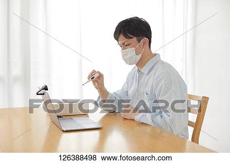 Sick Japanese man working from home View Large Photo Image Stock Photo - Sick Japanese man working from home. Fotosearch