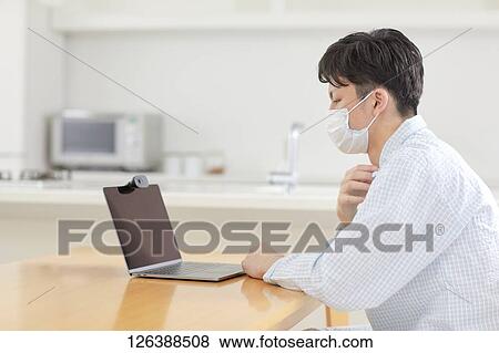 Sick Japanese man working from home View Large Photo Image Stock Photo - Sick Japanese man working from home. Fotosearch