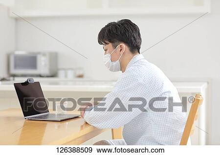 Sick Japanese man working from home View Large Photo Image Stock Photo - Sick Japanese man working from home. Fotosearch