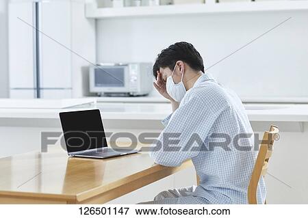 Sick Japanese man working from home View Large Photo Image Stock Photo - Sick Japanese man working from home. Fotosearch