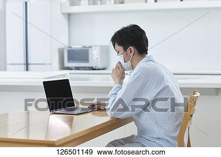 Sick Japanese man working from home View Large Photo Image Stock Photo - Sick Japanese man working from home. Fotosearch