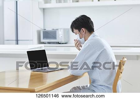 Sick Japanese man working from home View Large Photo Image Stock Photograph - Sick Japanese man working from home. Fotosearch