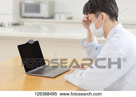 Sick Japanese man working from home View Large Photo Image Stock Photography - Sick Japanese man working from home. Fotosearch