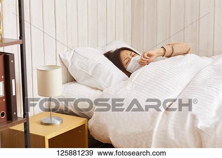 Stock Photo - Sick Japanese woman at home. Fotosearch