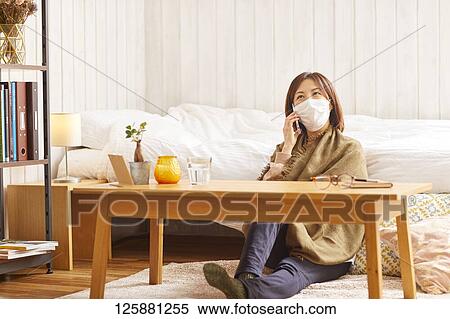 Stock Photography - Sick Japanese woman at home. Fotosearch