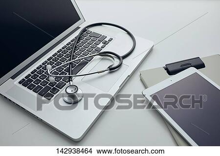 Picture - Stethoscope and laptop. Fotosearch