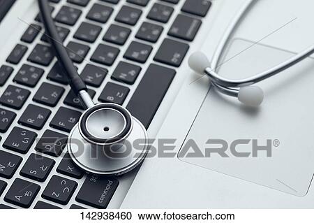 Stock Image - Stethoscope and laptop. Fotosearch