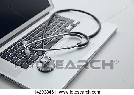 Stock Image - Stethoscope and laptop. Fotosearch