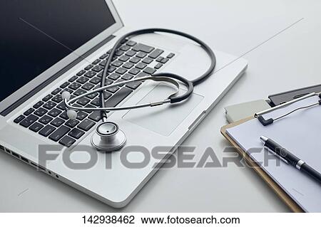 Stock Image - Stethoscope and laptop. Fotosearch