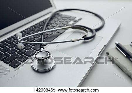 Stock Photography - Stethoscope and laptop. Fotosearch