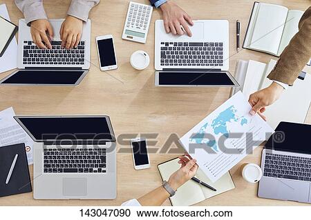 Top-down view of business people working in the office View Large Photo Image Stock Image - Top-down view of business people working in the office. Fotosearch