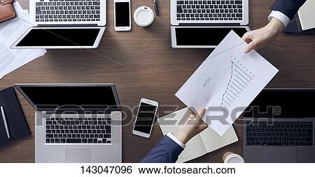 Top-down view of business people working in the office View Large Photo Image Stock Photograph - Top-down view of business people working in the office. Fotosearch
