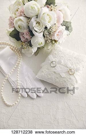 Stock Photo - Wedding Rings With A Bouquet And Globes. Fotosearch