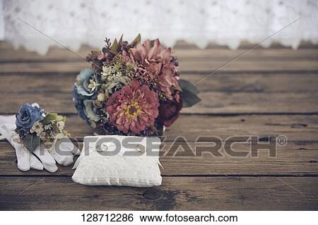 Stock Photograph - Wedding Rings With Flowers. Fotosearch