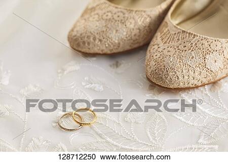 Stock Image - Wedding Rings With Women Shoes. Fotosearch