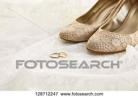 Stock Photo - Wedding Rings With Women Shoes. Fotosearch