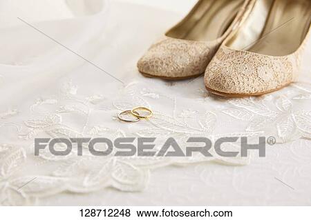 Stock Photo - Wedding Rings With Women Shoes. Fotosearch